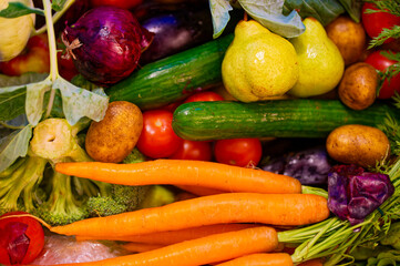 Various fresh ingredients for cooking such as potato, carrot, tomato and cucumber.