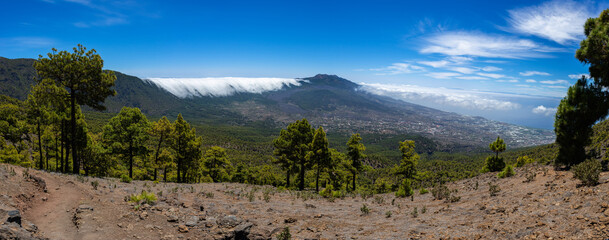 Clouds move over the mountain slope of Cumbre Nueva and flow into the valley like a waterfall, La Palma, Canary, Spain, Europe
