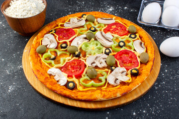 front view mushroom pizza with red tomatoes bell-peppers olives and mushrooms all sliced inside with eggs and flour on the grey desk food meal pizza