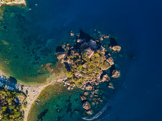 Italian seaside beach photographed by drone. Isola Bella, Taormina, Sicily.