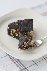 chocolate and cream cake on a plate on table 