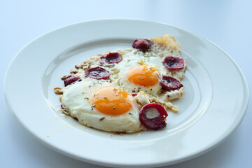 fried egg mixed with sausage on a plate 