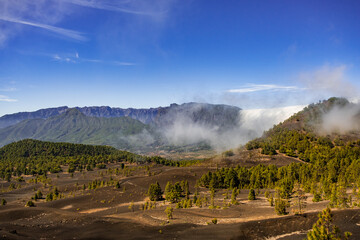 Clouds move over the mountain slope of Cumbre Nueva and flow into the valley like a waterfall, La Palma, Canary, Spain, Europe