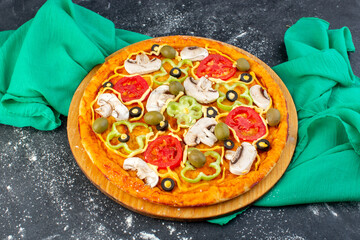 top view mushroom pizza with red tomatoes olives mushrooms all sliced inside on the grey background green tissue pizza dough italian