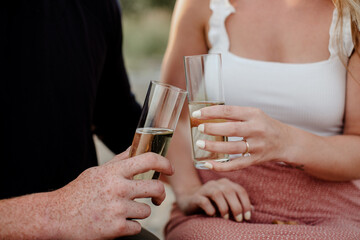 Newlywed couple sharing champagne after wedding ceremony.