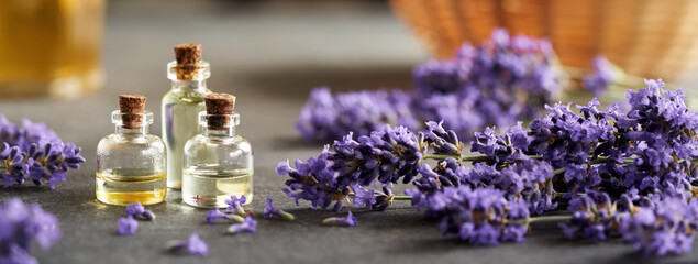 Horizontal header with aromatherapy essential oil bottles with blooming lavender
