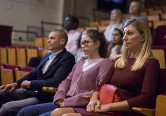 Portrait of a woman with interest watching a concert in the theater