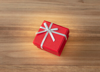 Red close gift box isolate on wood background. Copy space.