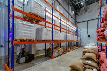 Bags with production on shelves in warehouse. Bags with coffee beans or sugar or other