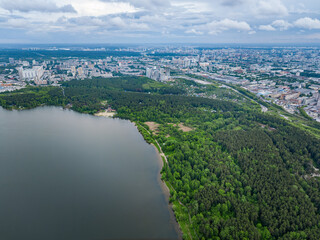 Obraz premium Big lake with green shores in bright sun light, aerial landscape. Recreation concept. Aerial view