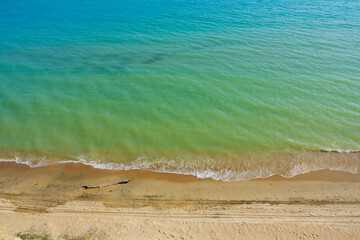 Surf on the sandy seashore, top view