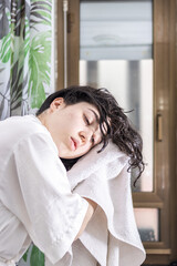 Girl drying her hair with the bath towel