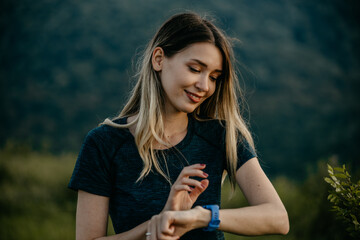 Jogging with a Digital Coach: A female jogger pairs her determination with the guidance of her smartwatch, which provides personalized feedback and motivation throughout her run in a picturesque natur