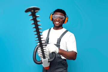 garden worker in uniform holding electric brush cutter on blue isolated background