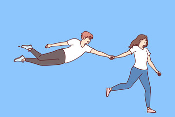 Woman says follow me and holds hand of flying man who wants to be always with girlfriend. Boyfriend floats through air follows girlfriend for concept of complete trust in partner in young family