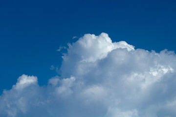 Fototapeta na wymiar Blue sky with white puffy fluffy clouds, horizontal natural background