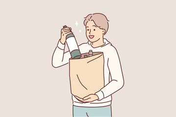 Man with bottle of wine in paper bag returns from grocery store and offers to drink bordeaux