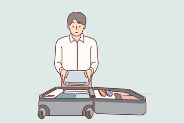 Business man puts clothes in suitcase on wheels going on official trip to sign important contract