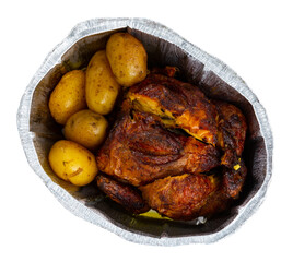 Whole chicken baked with potatoes in tinfoil deep bowl. Isolated over white background