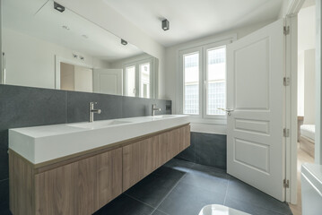 Fototapeta na wymiar Photo of a beautiful contemporary bathroom with a long double sink