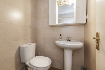 Fototapeta na wymiar Small bathroom with essential white porcelain toilets
