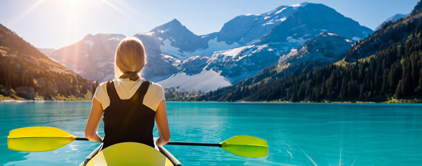 beautiful woman on a kayak on a big lake with big mountains