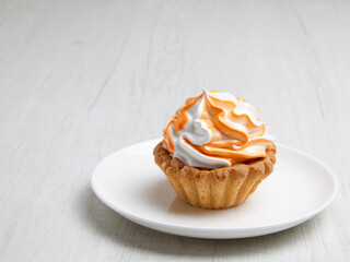Homemade cake on a white plate stands on a wooden table. set . selective focus 