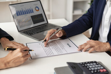 Obraz premium The right candidate gives the interviewer a resume during a job interview in a modern office conference room. woman submitting job application The interviewer reads the resume.