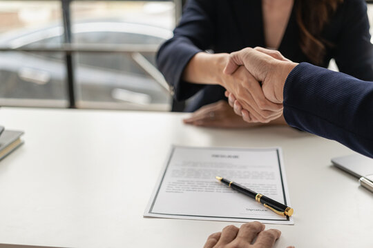 Job interview. Two businessmen shake hands to submit resume documents. HR manager shakes hands congratulating job candidates for successful job application close up pictures