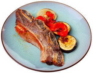 Nicely served plate of tasty brazilian barbecued steak with eggplants and chili peppers. Isolated...