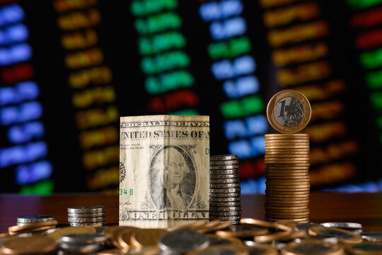 cedula of a US dollar and a Brazilian currency on a financial chart, valuation of the Brazilian currency