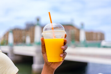 Take away glass of orange juice to enjoy the summer heat and hydrate - obrazy, fototapety, plakaty