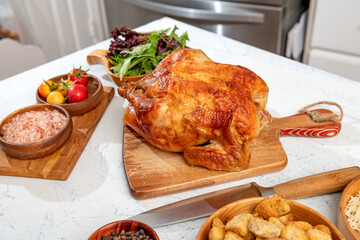 grilled chicken with vegetables and spices, grated cheese and breadcrumbs. on the kitchen table. Salad preparation ingredients.