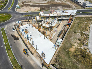 Aerial view of construction site with crane and building. Top view of big development construction and architecture.