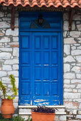 Fototapeta na wymiar Blue door on stone House 