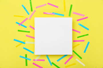 Blank card with confetti on yellow background