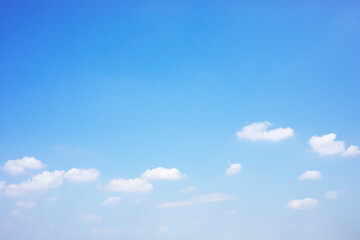 Blue sky background and white clouds soft focus, and copy space horizontal shape.