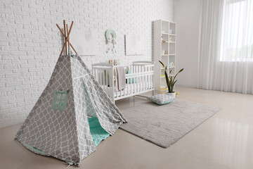 Fototapeta na wymiar Stylish modern interior of children's room with baby bed and play tent
