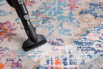 Hoovering carpet with vacuum cleaner, closeup and space for text. Clean trace on dirty surface