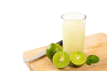 Glass of lime juice with fresh on white 