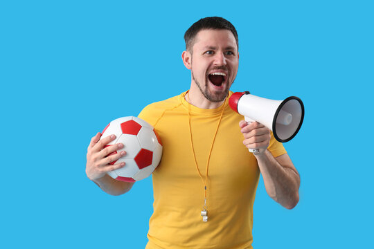 Male coach with soccer ball and megaphone on blue background - Powered by Adobe