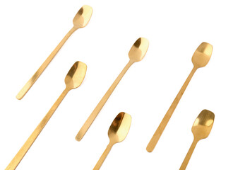 Golden spoons on white background