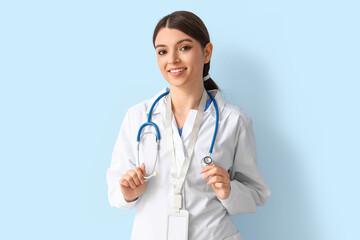 Female doctor with stethoscope on blue background