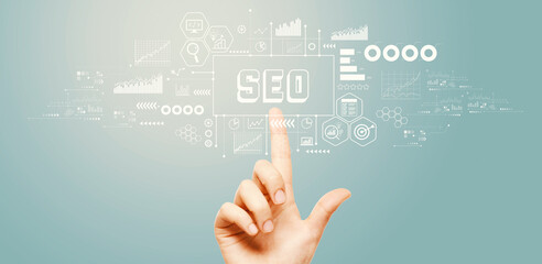 SEO - Search Engine Optimization theme with hand pressing a button on a technology screen