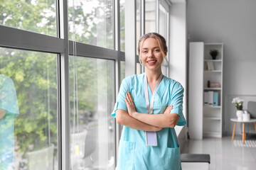 Female medical intern near window in clinic