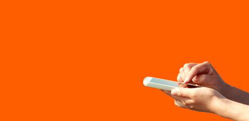 Person using a smartphone on a simple colored background