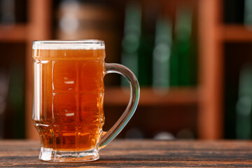 Mug of beer on table in bar. Oktoberfest celebration