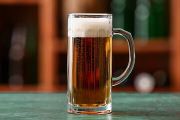 Mug of beer on table in bar. Oktoberfest celebration