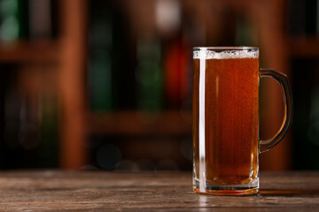 Mug of beer on table in bar. Oktoberfest celebration