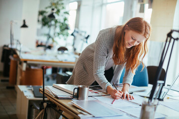 Young female architect working on a project in the office